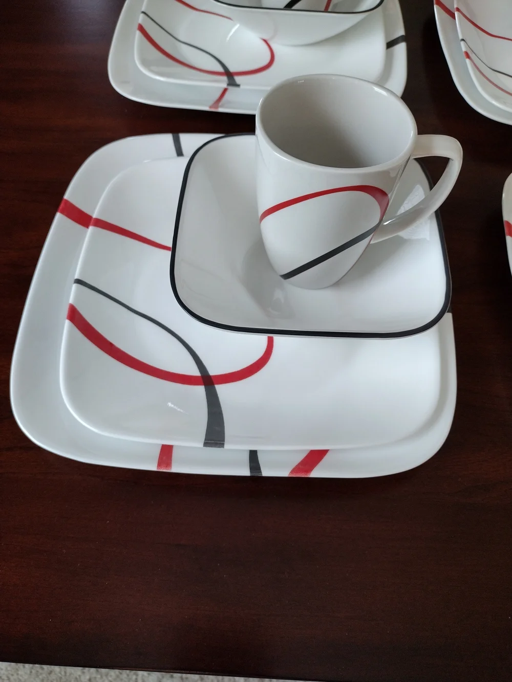 Corelle White Dinnerware Set with Red and Black Swirl Accents